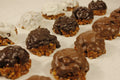 Assorted chocolate-dipped pralines on a white surface